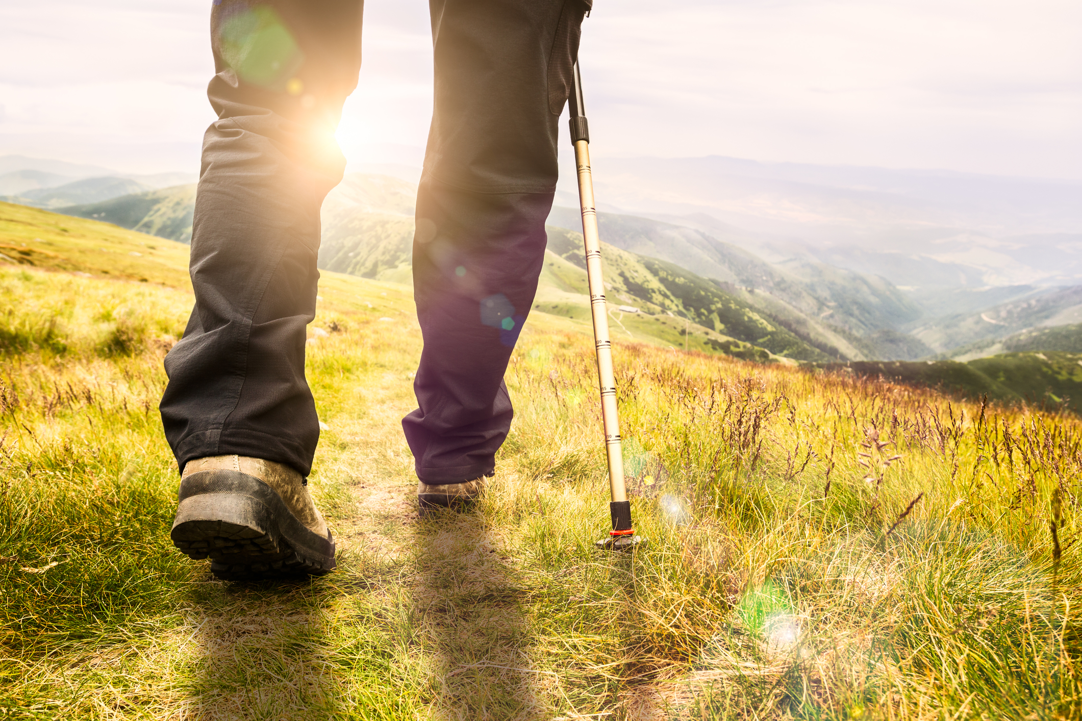 Man hiking towards the sun